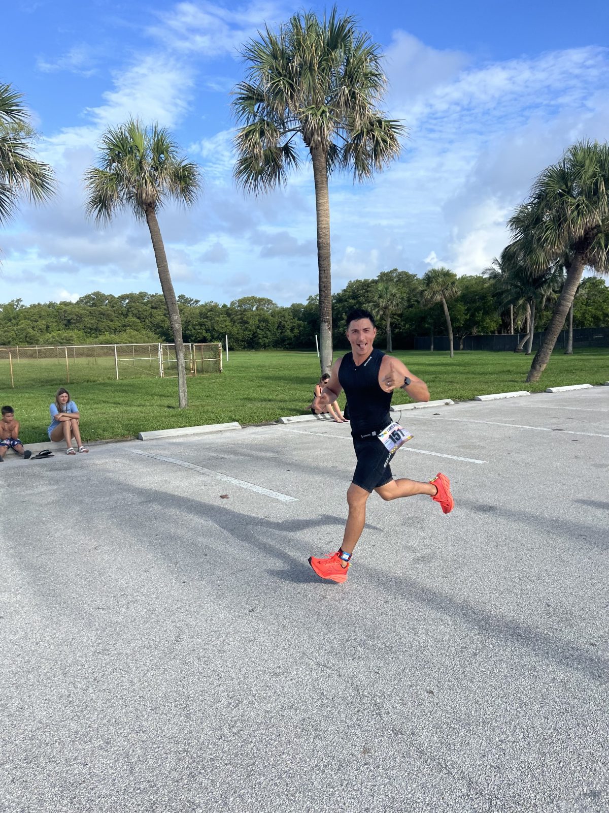 a young boy riding a skateboard up the side of a road