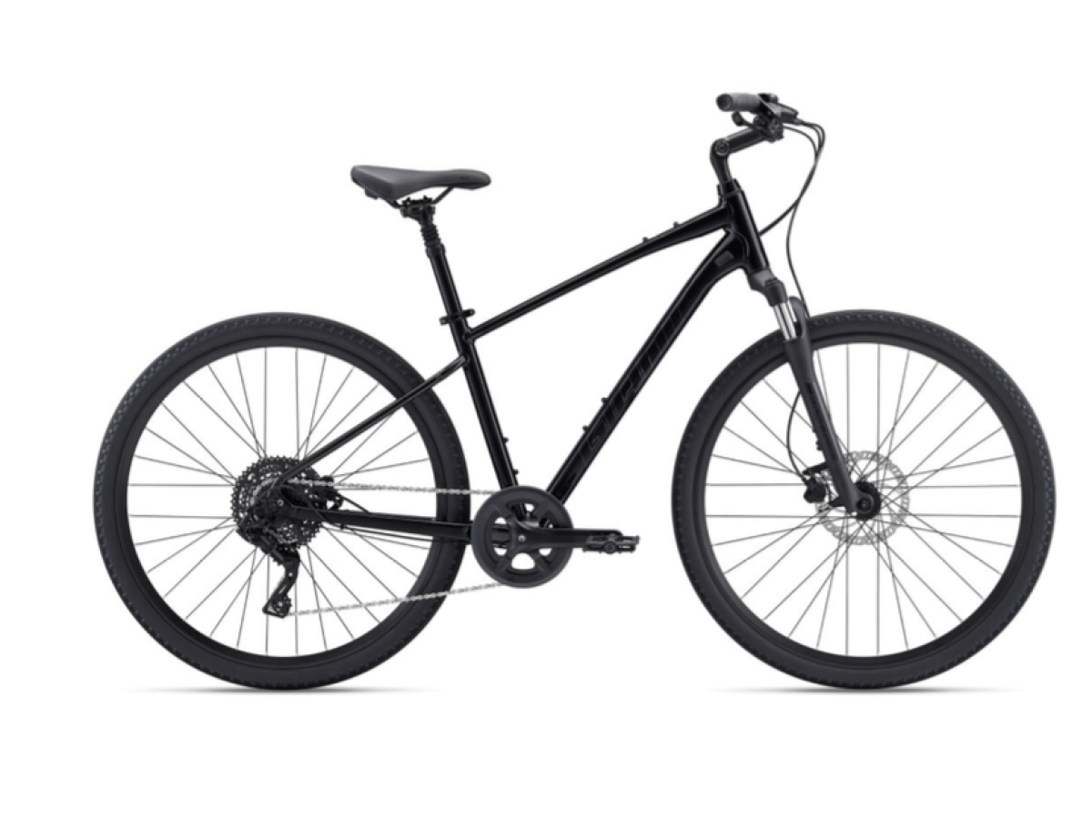 Black hybrid bicycle with disc brakes and straight handlebars on white background.