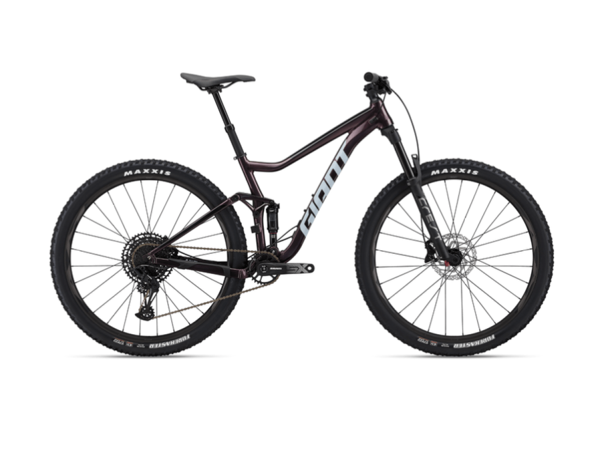 A modern mountain bike with thick tires and a suspension fork, viewed from the side on a white background.