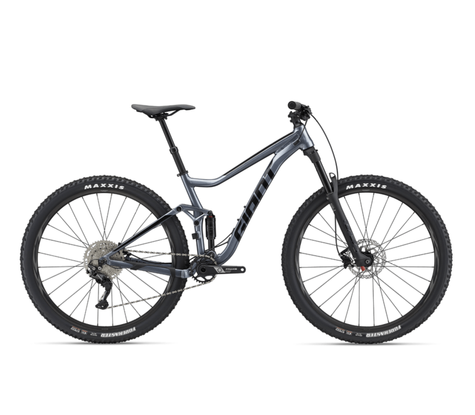 Full-suspension mountain bike with large tires, grey frame, and disc brakes on a white background.
