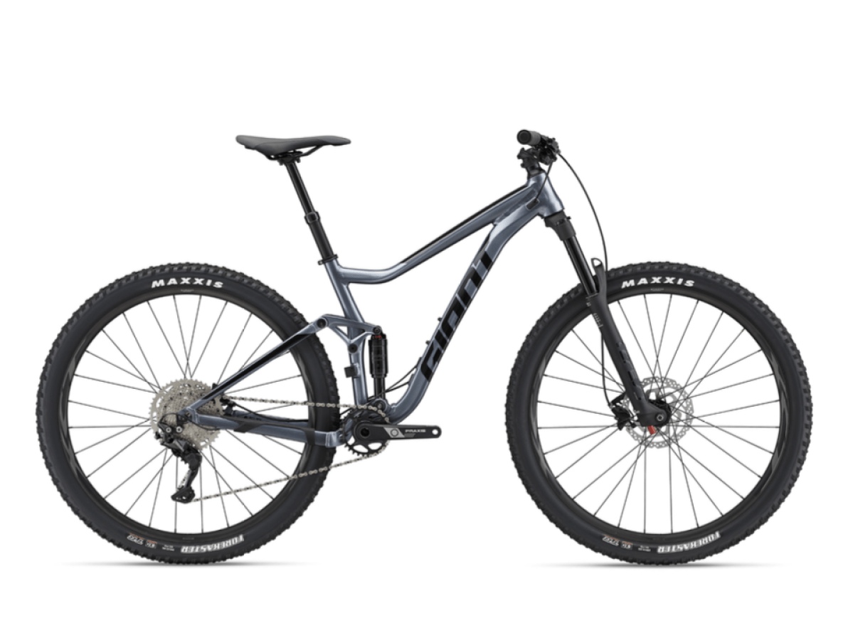 Full-suspension mountain bike with large tires, grey frame, and disc brakes on a white background.